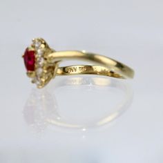 A wonderful cocktail ring by Kurt Wayne.  In 18K yellow gold with a half-twist to the shank. The shank supports a gallery with a central pear-cut ruby and 10 small round cut diamonds.   A high-level ring from the famous New York jewelry designer!  Marked to the shank 750 for 18k gold fineness and with a conjoined KW for Kurt Wayne.  Ring Size: ca. 5 1/2  Dimensions reference the ring size and are not specific to the ring itself. Pear-shaped Brilliant Cut Yellow Gold Ruby Ring, Pear-shaped Yellow Gold Ruby Ring With Center Stone, Yellow Gold Pear-shaped Ruby Ring With Center Stone, Pear-shaped Ruby Ring In Yellow Gold, Pear-shaped Ruby Ring In Yellow Gold With Center Stone, Elegant Pear-shaped Ruby Ring With Center Stone, Pear-shaped Gold Ruby Ring With Diamonds, Pear-shaped Ruby Diamond Ring In Gold, Yellow Gold Ruby Ring With Prong Setting