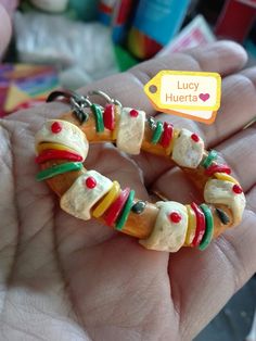 a person is holding a small bracelet made out of candy and marshmallows