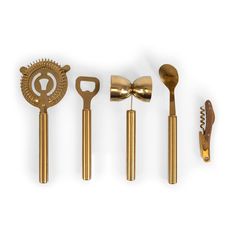 five golden kitchen utensils lined up in a row