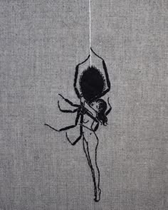 a spider is hanging on the side of a wall