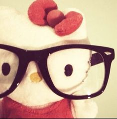 a teddy bear wearing glasses and a hello kitty hat on top of it's head