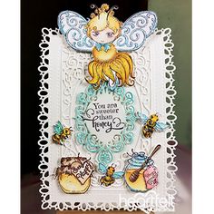 an ornate card with a little fairy on it's side and some decorations around the edges