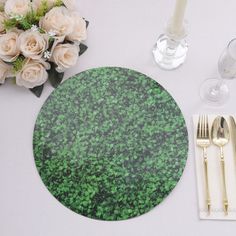 there is a place setting with flowers and silverware on the table, along with two champagne glasses