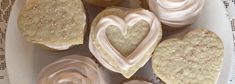 cupcakes with frosting in the shape of hearts on a plate