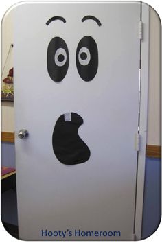 a white refrigerator with a face drawn on it