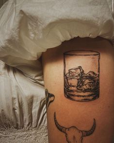 a bull's head with a glass of whiskey on the side of his leg