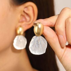 ✦ Indulge in the feminine elegance of our Textured Two Tone Abstract Fan-Shaped Shell Drop Earrings. With a unique fan shape and textured abstract design, these earrings exude a vacation summer feel. Choose between matte gold or glossy gold pendants to match your personal style. Perfect for a beach vacation, these high quality earrings will surely get you compliments. ----------- DETAILS----------- - *Sold in Pair - Color: Gold & Silver - Pattern: Matte Gold/ Glossy Gold - Glossy Gold (Length* W Bridal Party Beach, Anklet Stack, Dainty Anklet, Bracelet Emerald, Big Shell, Shell Light, Retro Earring, Statement Choker, Unique Pendant