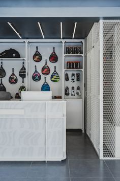 the inside of a store with various items on display and in front of it is a white counter