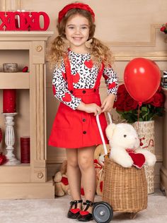 With a darling design as sweet as the little loves who don it, this festive suspender skirt set is ready for a full day of celebration. Boasting an easy slip-on fit with adjustable shoulder straps, the cute button-down design and unique animal print top make for an unbeatable outfit. Perfect for Valentine's Day, birthday parties, and year-round play Soft fabric blend is gentle on her skin and allows for stretch & holiday play The set features an animal print top with hearts and a red overall ski Playful Red Ruffled Sets, Cute Red Sets For Birthday, Cute Red Party Sets, Cute Fitted Sets For Holiday, Cute Fitted Holiday Sets, Cute Red Valentine's Day Dress, Plaid Overall Dress, Matching Costumes, Overall Skirt