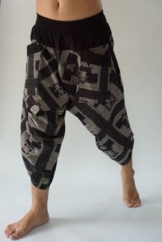 "Male Model Tall 5'9\" Waist 34\" Samurai Pants - elastic waistband and cuffs - Fits all! Unisex pants These beautiful casual pants is unique & comfortable to wear Handmade with a very lovely pattern, it is easy to wear and great for many occasions. One size fits most. These pants are great for many different activities like traveling, dancing, going to festivals, rock climbing, yoga, meditation, massage, working out, martial arts, Taichi MATERIAL: 100% Cotton APPROX MEASUREMENT: Waist: 24\" Baggy Patchwork Pants With Tapered Leg, Baggy Patchwork Tapered Leg Pants, Black Patchwork Bottoms For Festival, Bohemian Black Patchwork Bottoms, Black Relaxed Fit Pants For Festival, Yoga Harem Pants, Samurai Pants, Handmade Pants, Genie Pants