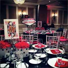 the tables are set for an event with red and white centerpieces