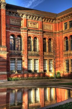 an old building with water in front of it