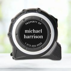 a black and white clock with the words property of michael harrison on it's face