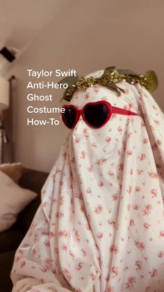 a bed covered in a blanket with red sunglasses on it and the words taylor swift anti - hero ghost costume how - to