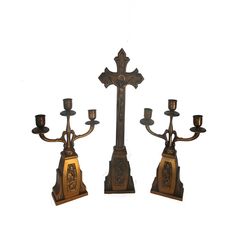 three candelabras with candles on them are standing in front of a white background