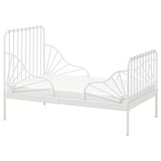 a white bed frame with two rails on the bottom and one end, in front of a