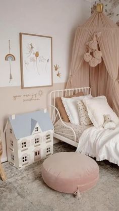 a white bed sitting in a bedroom next to a pink wall