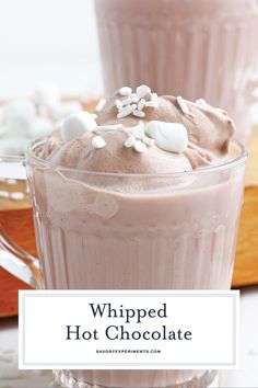 whipped hot chocolate in a glass mug with marshmallows on top and text overlay that says whipped hot chocolate