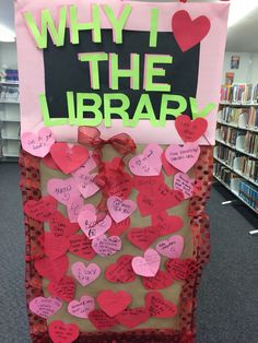 a library bulletin board with many hearts attached to it