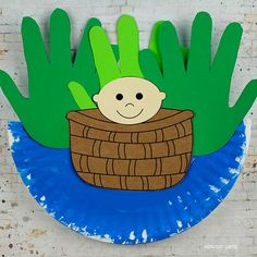 a paper plate with an image of a baby in a basket on top of it