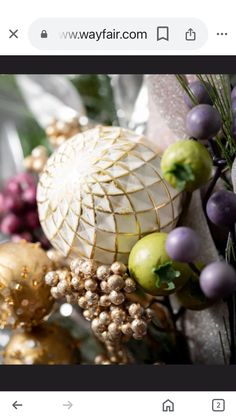 an image of a christmas decoration with gold and purple balls on it's side