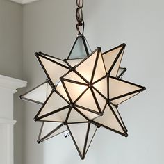 a moravian star light hanging from a ceiling