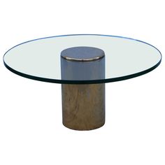 a round glass table with a metal base