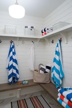 a bathroom with towels and baskets on the shelves