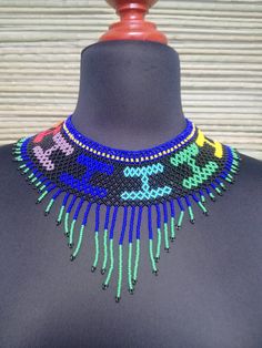 Mexican necklace, Huichol necklance, huchol choker, beaded choker. huichol art. This choker is a piece with a compound made by Huichol artisans, made entirely by hand, unique pieces, very colorful boho type, for any occasion. The Huichol artisans base all their works and their designs on visions they have during their sacred rituals proper to their ethnicity, The Huicholes inhabit the states of Nayarit, Jalisco, Zacatecas and Durango. Piece made by artisans nayaritas. Sent anywhere in the world Traditional Handwoven Choker Jewelry, Handmade Beaded Choker For Festivals, Handwoven Round Beads Choker For Festivals, Artisan Choker For Festivals, Artisan Choker With Colorful Beads For Festivals, Handwoven Artisan Choker For Festival, Artisan Large Beads Choker For Festivals, Artisan Handwoven Choker For Festival, Multicolor Handwoven Festival Choker