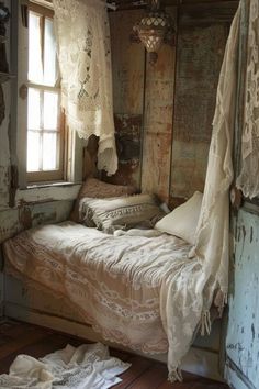 an old fashioned bedroom with two beds and curtains on the window sill above them