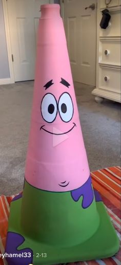 a large pink cone with eyes on it