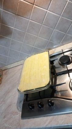 a piece of food is sitting on top of the burners in this kitchen stove