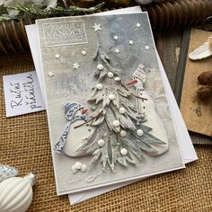 a card with a snowman and a christmas tree on it next to other cards