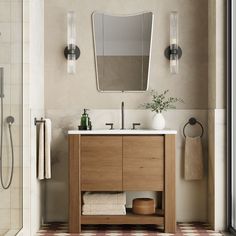 a bathroom with a sink, mirror and shower