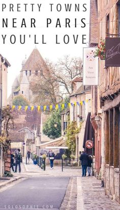 people walking down the street in an old european town with text overlay that says, pretty towns near paris you'll love