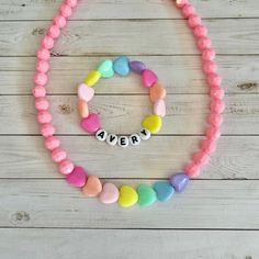 "This is a set of 2! You get a personalized name bracelet with colorful hearts AND the matching pink heart necklace.  This cute pastel, HEART necklace and bracelet set makes a great present for birthdays!  This 15\" stretchy necklace fits right over your head so it's easy to put on- no clasps needed.  🤍 Please check all selections and spelling prior to check out. Our custom jewelry is made to order so all sales are final.  🤍 This set is beautifully packaged and ready to gift. Receipts are neve Sweet Adjustable Personalized Jewelry, Personalized Adjustable Sweet Style Jewelry, Sweet Personalized Adjustable Jewelry, Cute Personalized Heart Bracelet For Birthday, Cute Personalized Heart Bracelet, Pink Heart Necklace For Birthday And Mother's Day, Playful Pink Jewelry For Mother's Day, Pink Heart-shaped Jewelry For Personalized Gifts, Heart-shaped Pink Jewelry For Personalized Gifts