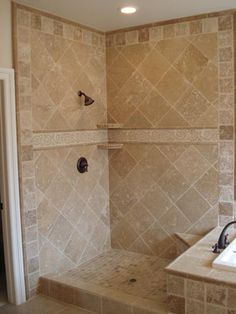 a bath room with a sink and a shower head mounted to the side of a wall