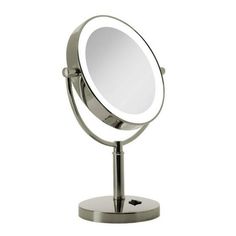 a round mirror sitting on top of a metal stand