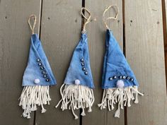 two pieces of cloth hanging from hooks with tassels and beads on the ends