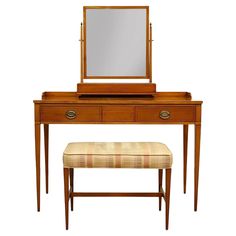 an antique dressing table with mirror and stool