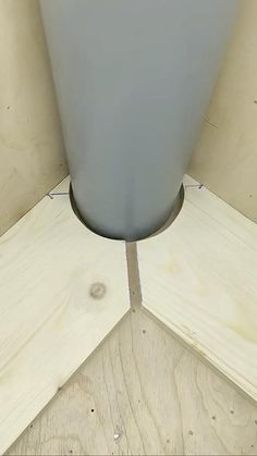 a gray vase sitting on top of a wooden floor