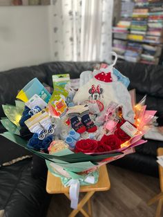 a bouquet of flowers sitting on top of a table in front of a black couch