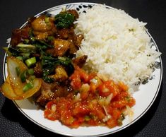 a white plate topped with rice and veggies