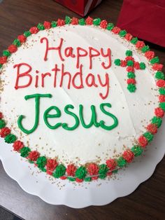 a birthday cake with the words happy birthday jesus written in green and red frosting