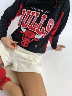 Our absolute favorite Chicago Bulls sweatshirt! Features the classic Chicago Bulls red coloring in the ribbed neckline and inner sleeves. The middle front of the sweatshirt showcases a beautiful print with the Chicago Bulls Logo. The perfect piece to pair with the AGOLDE 90's Pinch Waist Jean. 50% polyester 50% cotton Tag reads Official Licensed Product NBA - Made in USA Recommended for size xs-s, depending on the desired fit. Modeled on a small frame. Please refer to the measurements listed bel Winter Streetwear Tops With Raglan Sleeves, Graphic Print Raglan Sleeve Sweatshirt For Streetwear, Streetwear Sweatshirt With Raglan Sleeves And Ribbed Cuffs, Raglan Sleeve Sweatshirt With Ribbed Cuffs For Streetwear, Raglan Sleeve Tops For Fall Streetwear, Fall Streetwear Raglan Sleeve Sweatshirt, Fall Streetwear Tops With Raglan Sleeve, Fall Streetwear Sweatshirt With Raglan Sleeves, Fall Graphic Print Sweatshirt With Raglan Sleeves