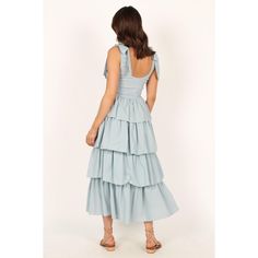 This gorgeous blue maxi dress is perfect to make a statement in! With its scoop neckline, tie close straps, shirred bodice and tiered layered skirt design it is sure to turn heads. Tiered Maxi Dress With Tie Back For Brunch, Square Neck Maxi Dress With Ruffles For Day Out, Light Blue Tiered Skirt Dress, Elegant Light Blue Tiered Maxi Dress, Spring Tiered Maxi Dress With Tie Straps, Tiered Maxi Dress With Smocked Back For Brunch, Tiered Maxi Dress With Tie Straps For Spring, Light Blue Ruffled Maxi Dress For Summer, Blue Tiered Maxi Dress With Ruffled Skirt