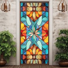 a stained glass door with potted plants on the side