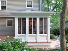 a gray house with white trim and windows