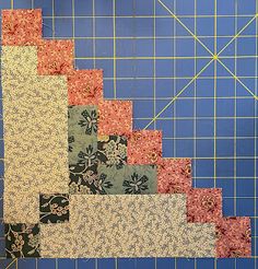 a quilter's cutting board with several different types of fabrics laid out on it