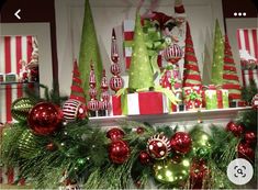 christmas decorations are displayed on the mantle